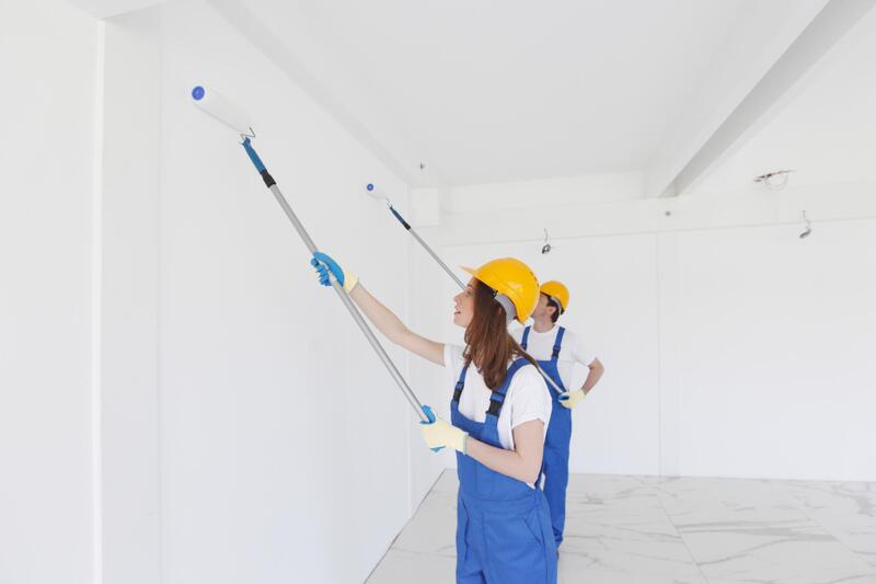 two people painting the walls
